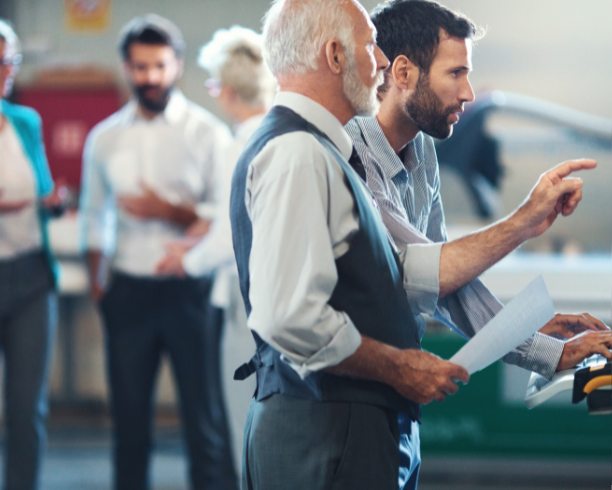 Business professionals engaged in discussion within a social setting