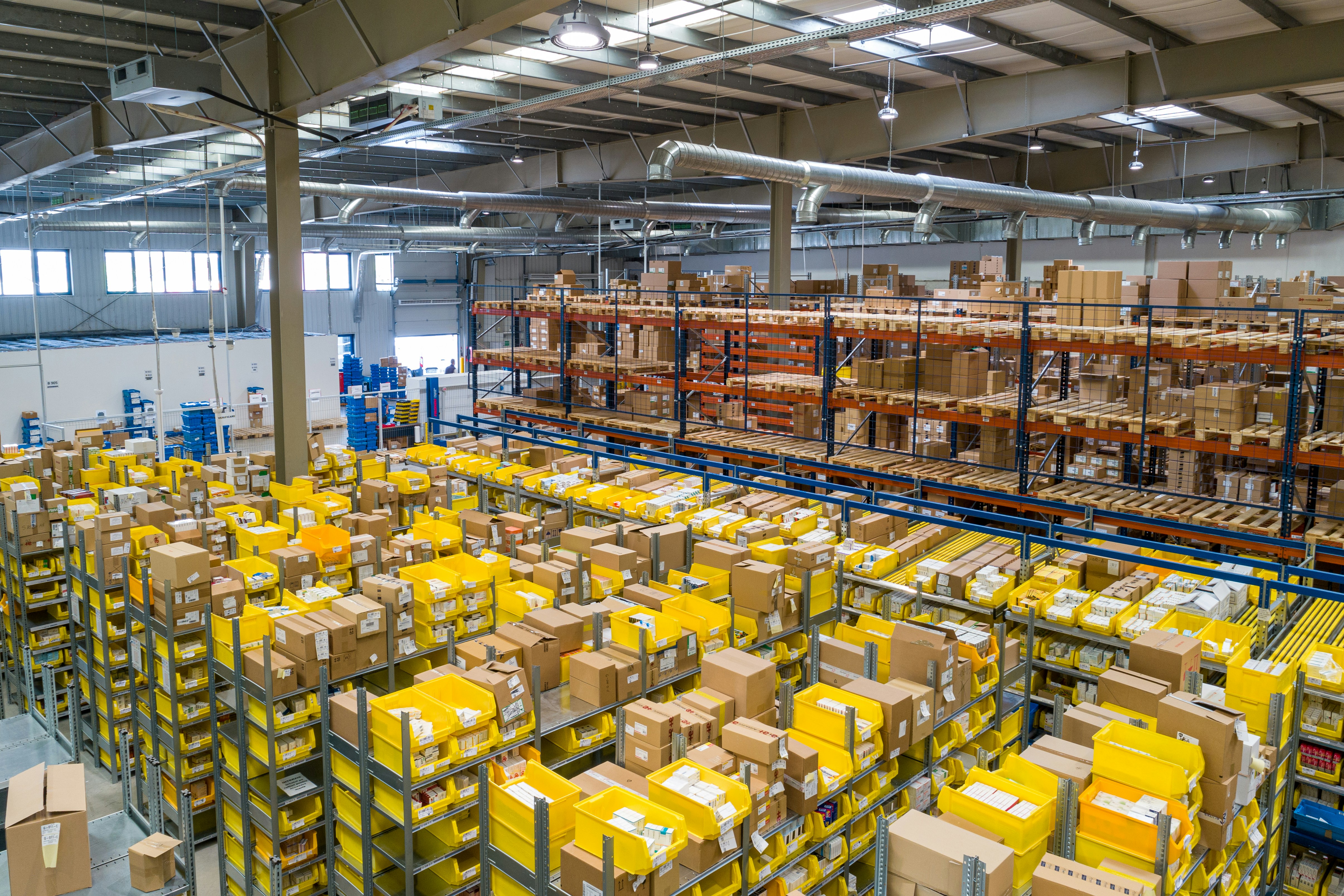 A spacious warehouse filled with numerous boxes stacked on shelves